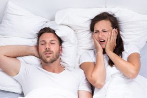 woman frustrated with man's snoring