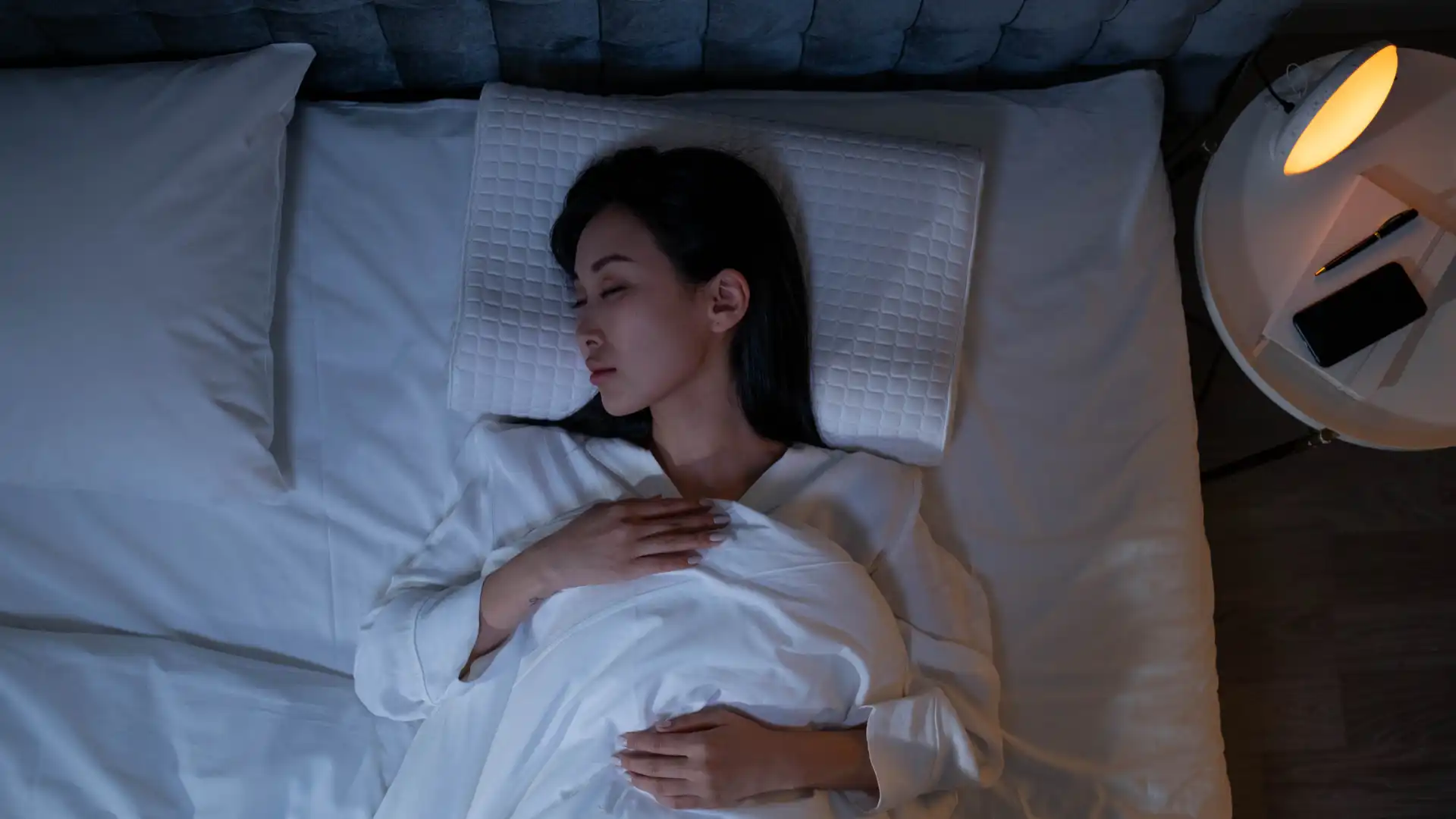 Person sleeping peacefully in bed at night