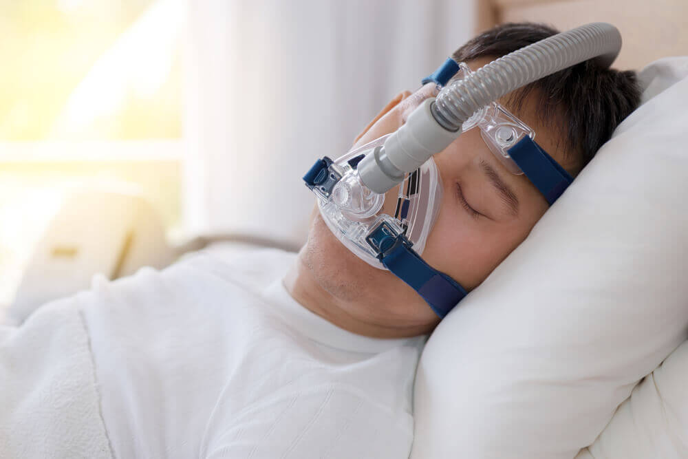 man sleeping while in therapy using machine
