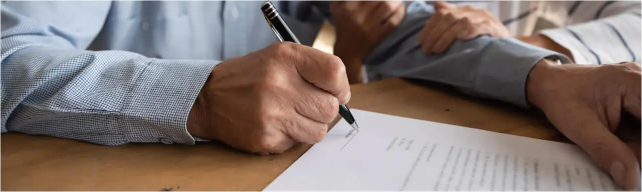 old man signing for a contract